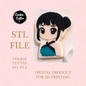 May include: A cookie shaped like an anime girl with black hair and a teal top. The cookie is decorated with white icing and black details. The image also includes text that says "STL FILE" and "DIGITAL PRODUCT FOR 3D PRINTING".