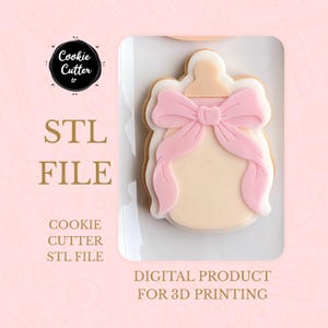 May include: A baby bottle-shaped cookie cutter design with a pink bow, white accents, and a beige center. The image includes the text "STL FILE" and "DIGITAL PRODUCT FOR 3D PRINTING". The cookie cutter is for 3D printing.