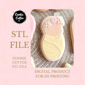May include: A baby-shaped cookie cutter design with a floral crown, surrounded by other cookies. The image includes the text "STL FILE" and "COOKIE CUTTER STL FILE". The background is a soft pink with the words "DIGITAL PRODUCT FOR 3D PRINTING".
