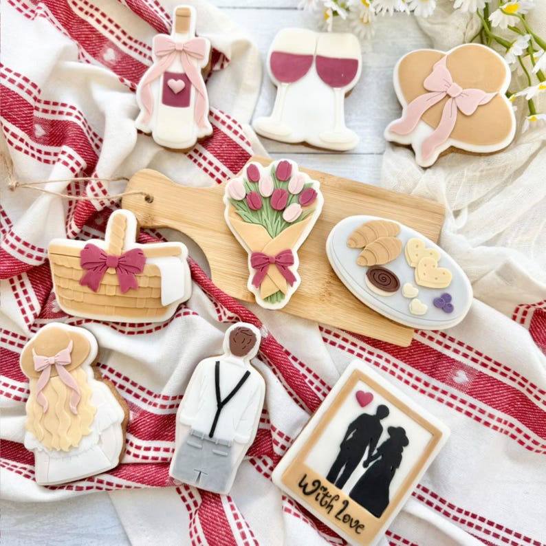 Hand-decorated pastel royal-icing sugar cookies in blush pink and ivory, artisanal gift cookies for weddings and Valentine's