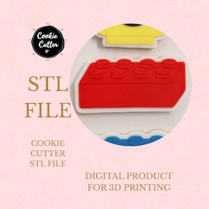 May include: A red and white cookie cutter in the shape of a building block, with the text "STL FILE" and "DIGITAL PRODUCT FOR 3D PRINTING". The image also features a logo that says "Cookie Cutter tr".