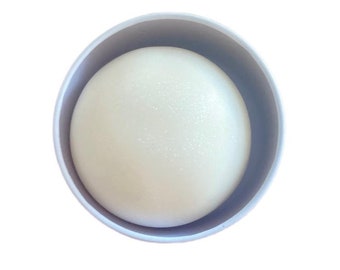 May include: A white, round, glittery soap bar in a light blue container.