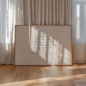 May include: A framed print with a white background and black text. The text reads: "The steadfast love of the Lord never ceases, his mercies never come to an end, they are new every morning, great is your faithfulness. Lamentations 3:22-23"