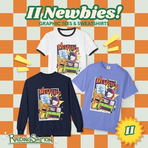 May include: A white ringer t-shirt, a navy blue sweatshirt, and a light purple t-shirt, each featuring a graphic print of cartoon characters and the text "NEWBIES". The background is an orange and white checkered pattern with yellow accents.