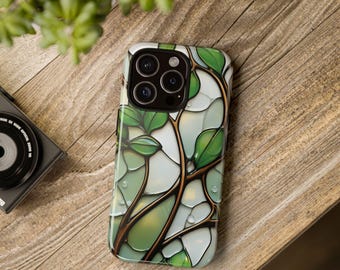 May include: A smartphone case featuring a stained glass design with dark brown branches and vibrant green leaves against a background of translucent white and pale green segments, with small clear water droplets scattered across the surface.