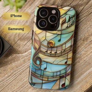 May include: A phone case with a colorful stained glass design featuring musical notes and a treble clef. The case is compatible with both iPhone and Samsung phones.