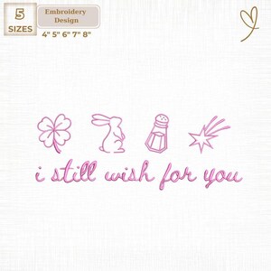 May include: Pink embroidery design with the text "i still wish for you" and illustrations of a four-leaf clover, rabbit, salt shaker, and shooting star. Includes sizes 4", 5", 6", 7", and 8".