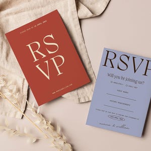 May include: Two RSVP cards, one red with white text and the other blue with black text. The red card says "RSVP" in large letters and the blue card says "RSVP Will you be joining us?" with a check box for "Absolutely!" and "Sadly not".