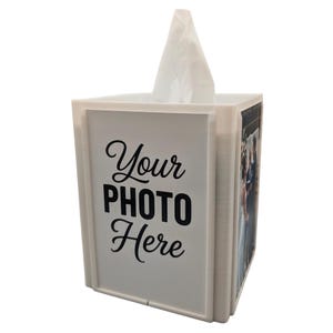 May include: A white tissue box with a rectangular design. The box features the text "Your PHOTO Here" in black script. A photo is visible on one side. White tissues are pulled from the top opening.