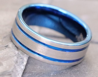 May include: A silver and blue ring with two silver bands around the center.