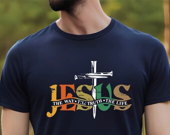 May include: Navy blue t-shirt with a colorful graphic design. The design features the word "JESUS" in orange, green, and brown, with a white cross and the text "THE WAY THE TRUTH THE LIFE".