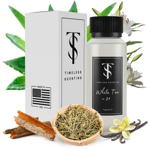 May include: A white bottle of White Tea fragrance oil, labeled "Timeless Scenting" and "White Tea no. 21". The bottle is surrounded by white flowers, green leaves, and cinnamon sticks.