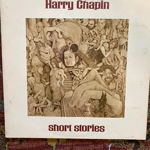 May include: Vintage vinyl record album cover for Harry Chapin's "Short Stories." The cover features a sepia-toned illustration of multiple figures and a guitar. The album title and artist's name are in a dark red font.