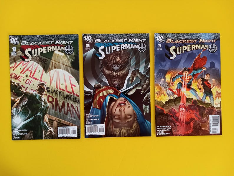 以下が含まれることがあります： 「Blackest Night」シリーズのスーパーマンのコミック3冊。鮮やかなイラストとスーパーマンのロゴが特徴です。表紙には、鮮やかな色とダイナミックなキャラクターのポーズで描かれたアクションシーンが、黄色の背景に描かれています。