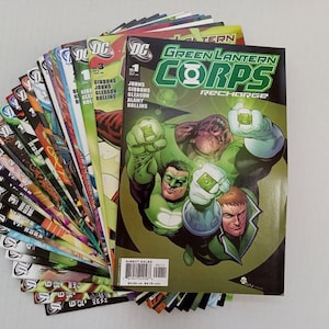 Op de afbeelding: Een verzameling Green Lantern Corps-strips van DC Comics. De cover van nummer 1 toont een groenhuidige alien en twee menselijke personages. De strips zijn in een waaier gerangschikt, met verschillende covers zichtbaar.