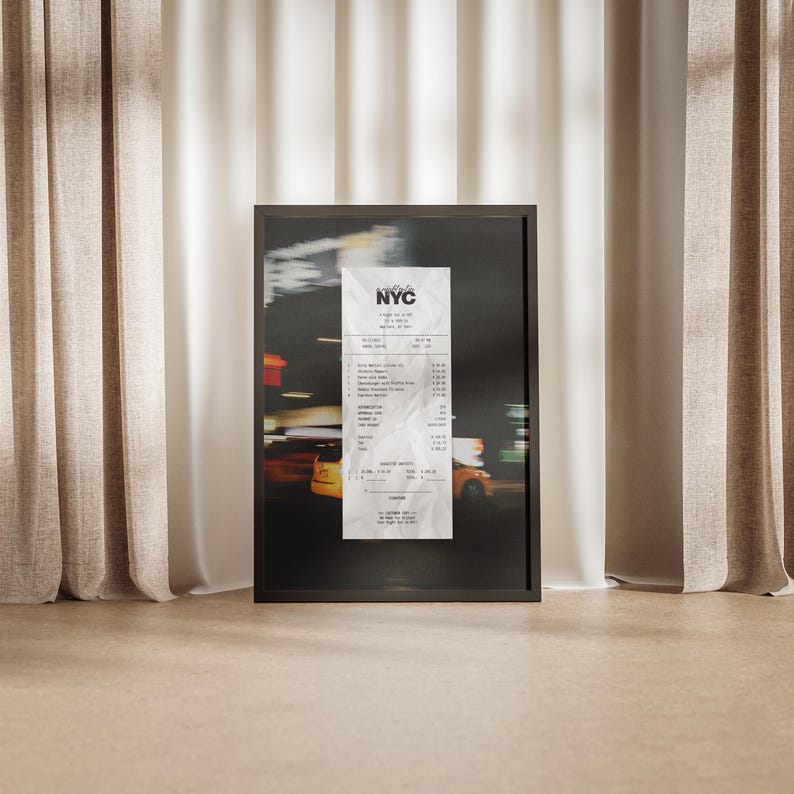 May include: A framed print depicting a blurred night street scene with a central receipt. The receipt, labelled "NYC", is detailed with itemised listings. The frame is dark, and the background shows yellow taxi cabs.