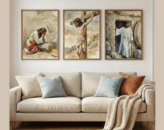 May include: Three framed watercolor paintings depicting religious scenes. The first shows a figure in prayer, the second depicts a crucifixion, and the third shows a figure emerging from a tomb. The paintings hang above a beige sofa with pillows and a throw.