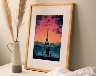 May include: A framed print of the Eiffel Tower in Paris, France. The print features a couple silhouetted in the foreground, with a pink and orange sunset sky in the background. The text "Paris, France" is printed at the top of the print.