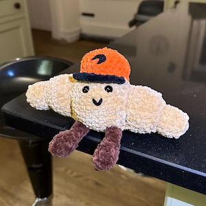 Handmade Amigurumi Croissant Plushie with F1 Team Custom Hat | Adorable Crochet Formula 1 Plush Toy