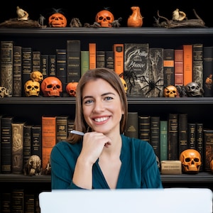 May include: A woman smiles while sitting in front of a bookshelf decorated with Halloween-themed items, including pumpkins, skulls, and spiders. The bookshelf is filled with books, many of which are antique and have leather bindings.