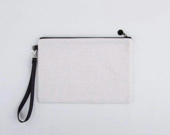 May include: A white canvas zippered pouch with a black zipper and a black strap.