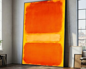 May include: Large framed abstract painting with a black border. The artwork features two large orange rectangles with a horizontal yellow band in the center, set against a yellow background. The painting leans against a wall in a room with a window.