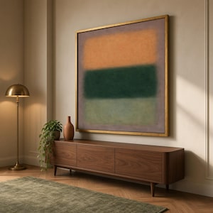 May include: A large square wall art piece featuring three horizontal color blocks in shades of orange, dark green, and light green, framed in a thin gold border. The painting displays soft, blended edges between the distinct color sections.
