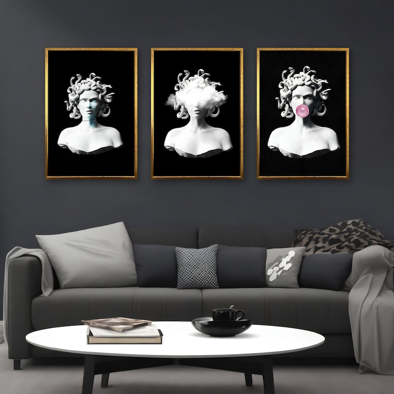 May include: Three framed art prints featuring white busts of Medusa with gold frames against a black background. One bust has a cloud for hair, another has a bubblegum bubble, and the third has a blue glow.