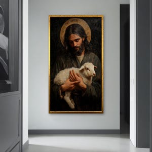 May include: A painting of a man holding a white lamb in his arms. The man is wearing a dark robe and has a halo above his head. The background is dark and the painting is framed in gold.