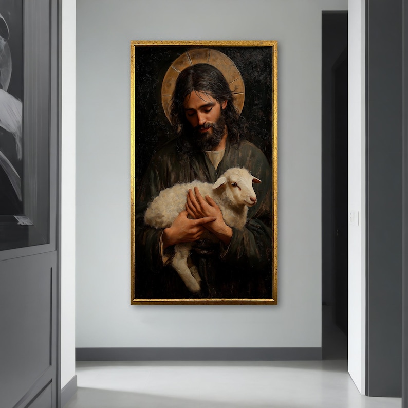 May include: A painting of a man holding a white lamb in his arms. The man is wearing a dark robe and has a halo above his head. The background is dark and the painting is framed in gold.