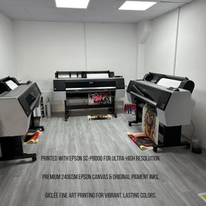 May include: A print shop featuring three large-format printers. The printers are black and gray, with printed artwork visible. The text on the image states: "PRINTED WITH EPSON SC-P8000 FOR ULTRA-HIGH RESOLUTION. PREMIUM 240GSM EPSON CANVAS & ORIGINAL PIGMENT INKS. GICL&Eacute;E FINE ART PRINTING FOR VIBRANT, LASTING COLORS."
