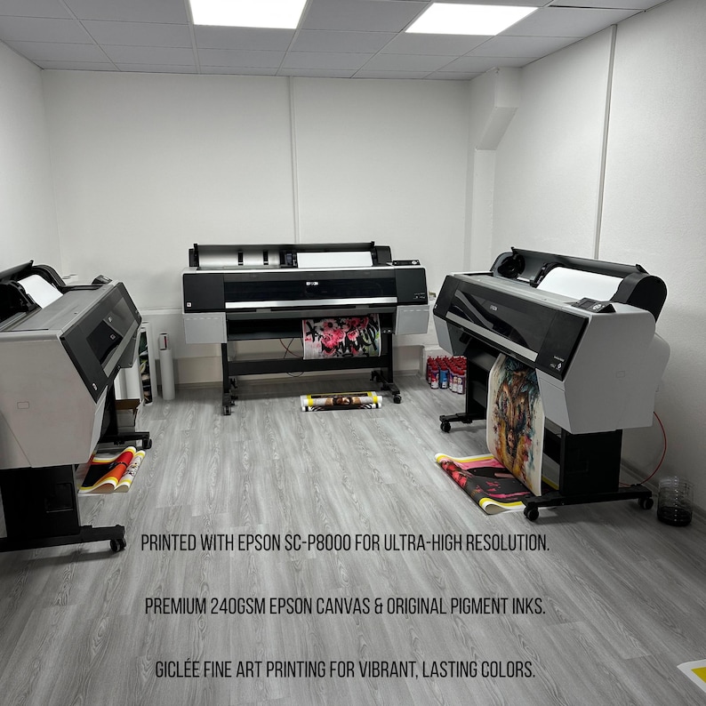 May include: A print shop featuring three large-format printers. The printers are black and gray, with printed artwork visible. The text on the image states: "PRINTED WITH EPSON SC-P8000 FOR ULTRA-HIGH RESOLUTION. PREMIUM 240GSM EPSON CANVAS & ORIGINAL PIGMENT INKS. GICL&Eacute;E FINE ART PRINTING FOR VIBRANT, LASTING COLORS."