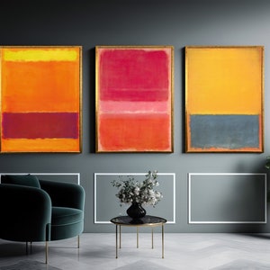 May include: Three abstract paintings in gold frames, each with a different colour scheme. The first painting is yellow, orange, and red. The second painting is red, pink, and orange. The third painting is yellow and blue.