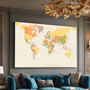 May include: A large, rectangular world map print with a vintage aesthetic. The map features a cream-colored background with colorful countries and oceans. The map is mounted on a wall above a blue sofa.