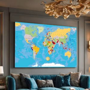 May include: A large, colorful world map displayed on a wall. The map features a detailed depiction of continents and countries, with each nation distinguished by a unique color. The oceans are a bright blue, and the map is framed.