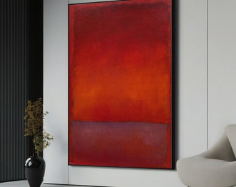 May include: Abstract painting with a red, orange, and purple color scheme. The painting is framed in black and hangs on a white wall.