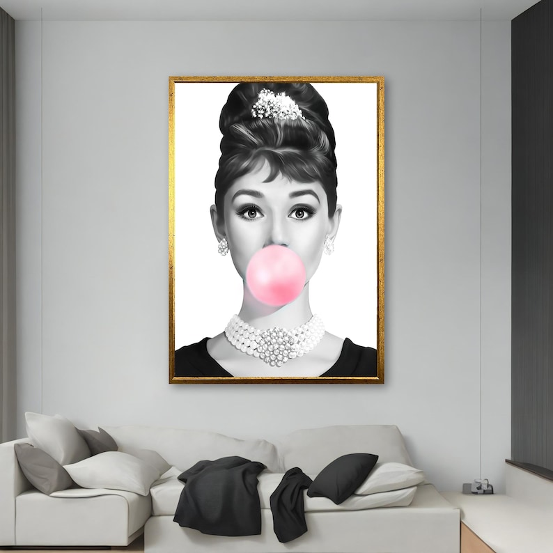 May include: Black and white portrait of a woman with a large pink bubble gum in her mouth. She is wearing a pearl necklace and a black dress.