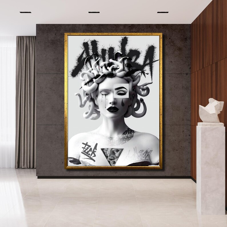 May include: Black and white illustration of a woman with snakes for hair. The woman has a tattoo on her chest and the word "HUIZA" is written in graffiti style above her head.