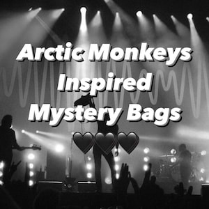 May include: Monochrome image displaying the text "Arctic Monkeys Inspired Mystery Bags" with heart symbols. The background shows a concert scene with silhouettes of performers and an audience, lit by stage lighting.