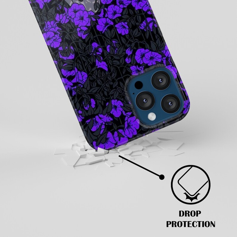May include: A black phone case with a purple floral pattern. The case has a raised camera bump with three lenses. The case is shown on a broken white surface with a drop protection icon.