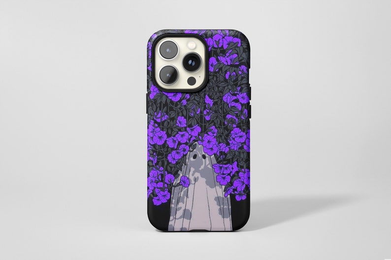 May include: A black phone case with a purple floral design and a white ghost in the center.