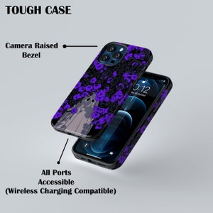 May include: A black phone case with a purple floral design and a ghost graphic. The case has a raised camera bezel and is compatible with wireless charging. The text "0:12 Say 20 October" is displayed on the phone screen.