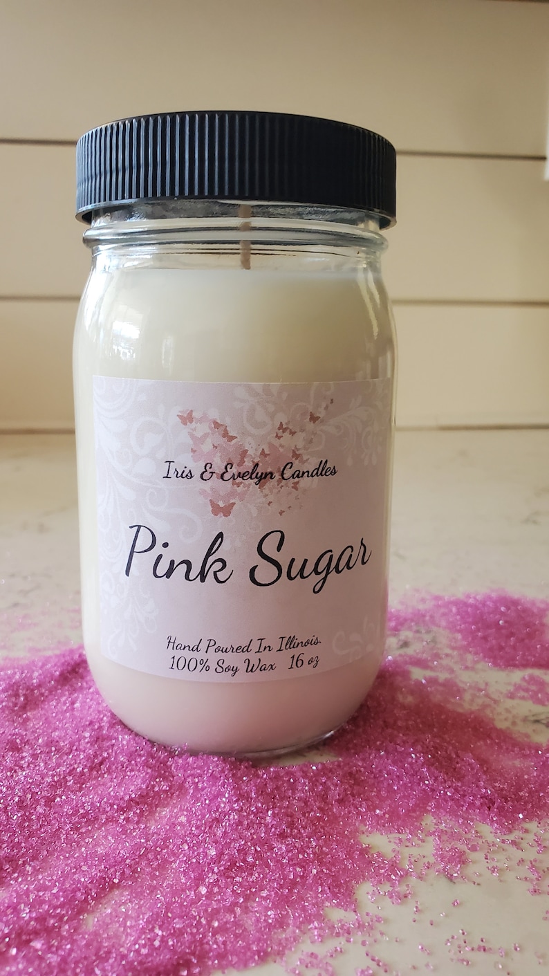 Pink Sugar candle, made with all-natural soy wax and a cotton wick for a clean and long-lasting burn.  A fragrance oil with notes of cotton candy, bergamot, Sicilian orange, and fig leaves. With mid notes of licorice blossom and lily of the valley.