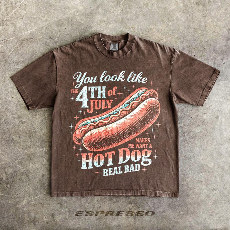 May include: Brown t-shirt with a graphic of a hot dog and the text "You look like the 4th of July makes me want a hot dog real bad." The word "espresso" is at the bottom.