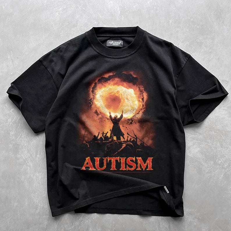 May include: Black t-shirt with a graphic of a person holding a fiery orb, surrounded by other figures. The text "AUTISM" is printed below the graphic.