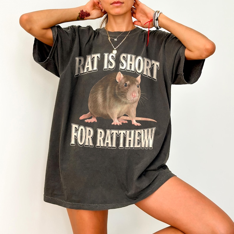 May include: A black oversized t-shirt with a graphic of a rat and the text "Rat is short for Ratthew".
