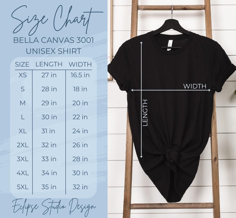 Pu&ograve; includere: Tabella delle taglie per magliette unisex Bella Canvas 3001. La tabella mostra la lunghezza e la larghezza in pollici per le taglie XS a 5XL. Una maglietta nera &egrave; mostrata su una scala di legno.