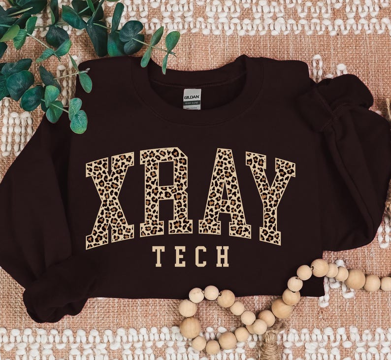May include: A maroon sweatshirt with a leopard print "XRAY TECH" graphic.