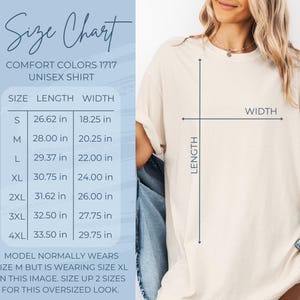 May include: Size chart for a unisex t-shirt in various sizes, showing length and width measurements in inches. The model is wearing a size XL t-shirt, which is two sizes larger than their usual size.