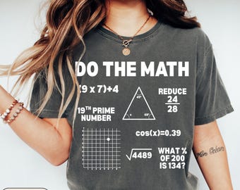 May include: Dark gray t-shirt with the text "DO THE MATH" and various mathematical equations and symbols. The shirt includes the text "19TH PRIME NUMBER" and "WHAT % OF 200 IS 134?"